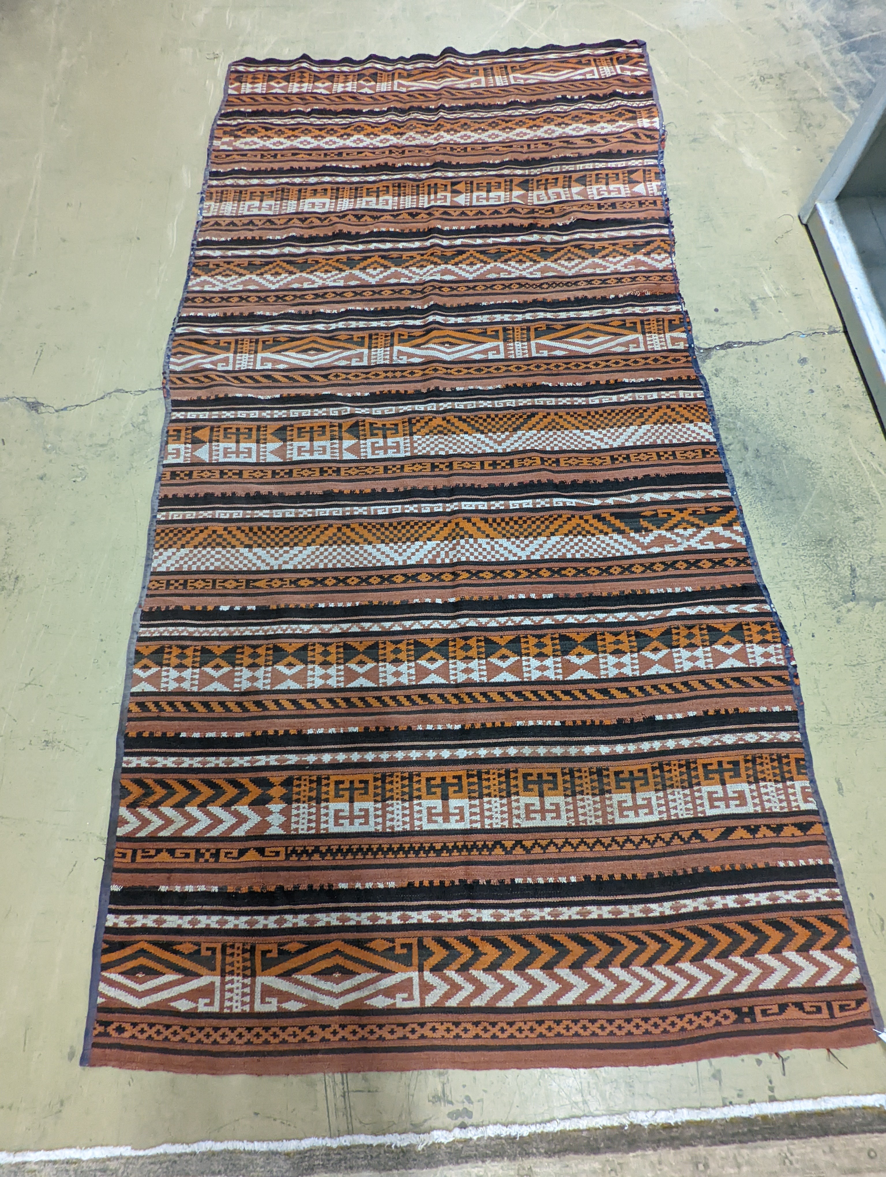 A polychrome flatweave carpet, approx. 330 x 180cm